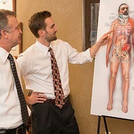 Mike Stephenson & Brady Rife looking at a medical diagram